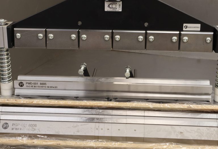 Metal cutting tool with adjustable clamps and multiple blades for precise cuts.