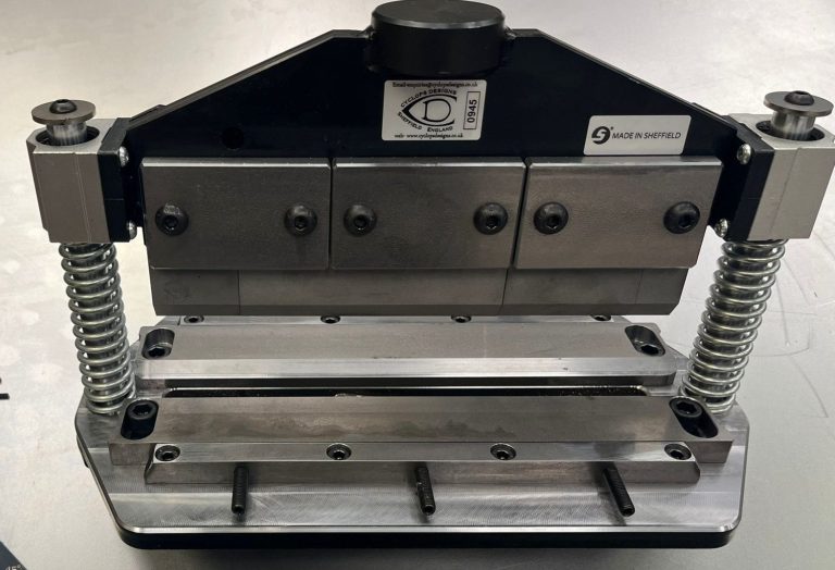 Metal cutting tool with adjustable clamps and multiple blades for precise cuts.